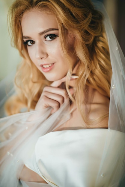 Lovely young woman bride in a lavish wedding dress