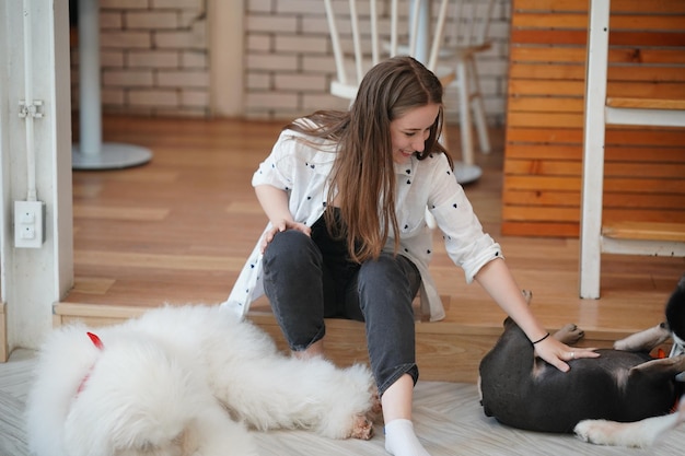 Lovely young woman playing with her dog