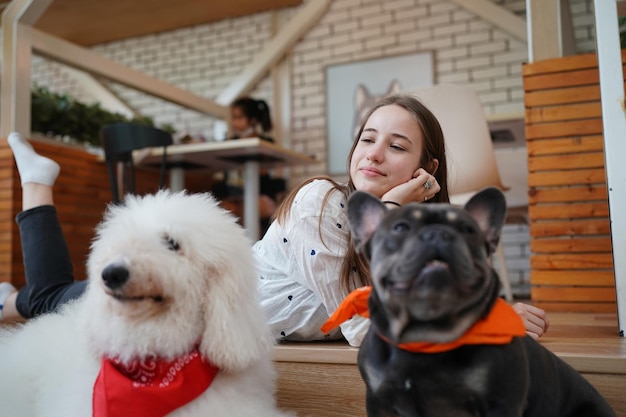 Lovely young woman playing with her dog