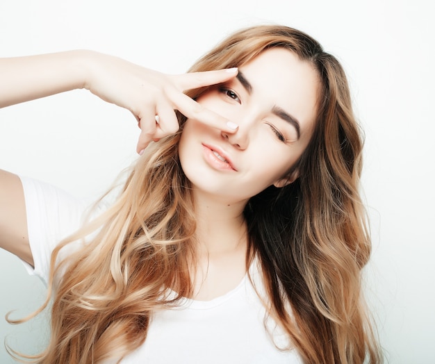 Lovely young woman showing victory or peace sign