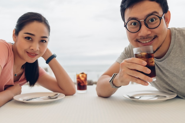 Lover couple having a date at the restaurant on the beach.