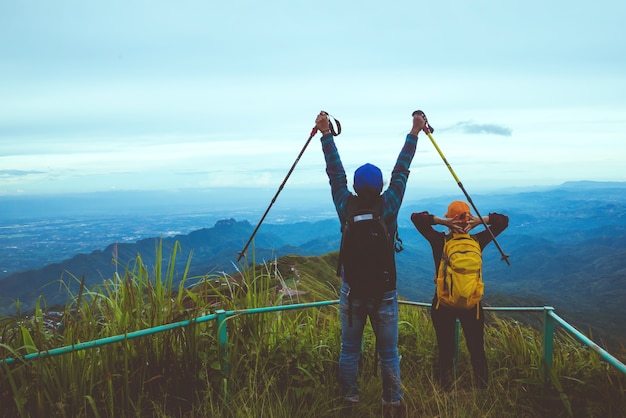 Lover woman and man Asian travel nature. Travel relax. Walk study the path Nature in the forest