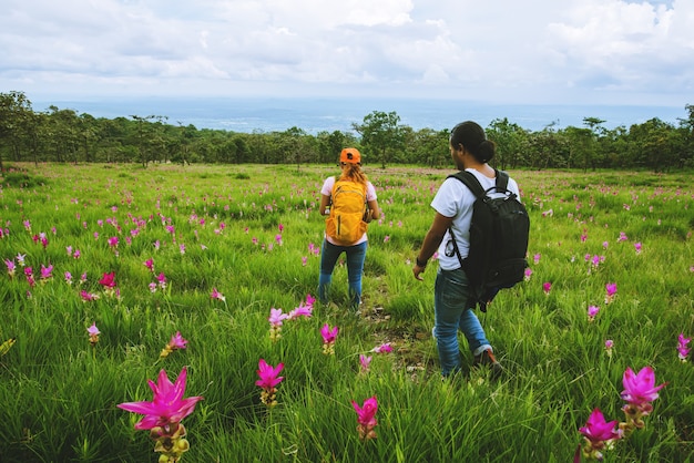 Lover woman and men Asian travel nature. Travel relax. Photography Cucumber sessilis flower field.