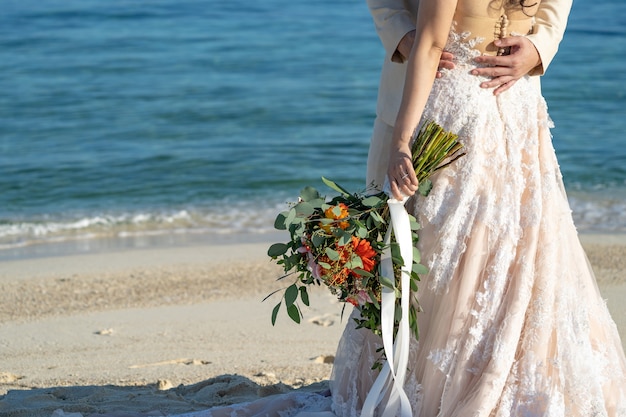 Photo lovers, bride and groom in love action, holding and stay beside together beside the beach