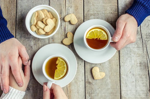 Lovers drinking tea. Selective focus. Drink hot.