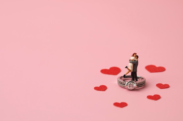 Photo lovers hugging in the ring on pink background