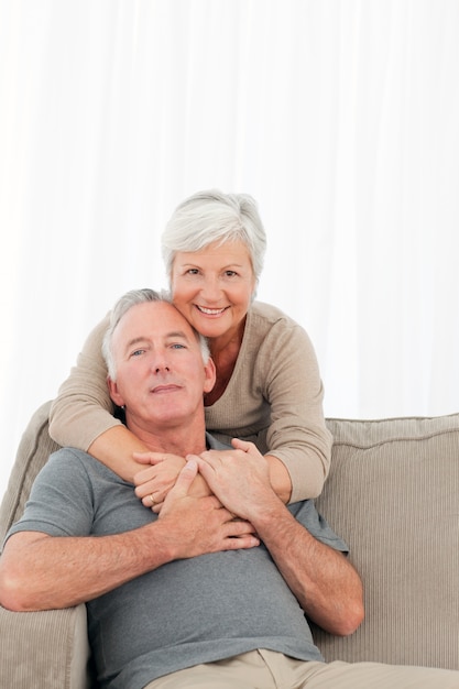 Lovers hugging while they are looking at the camera