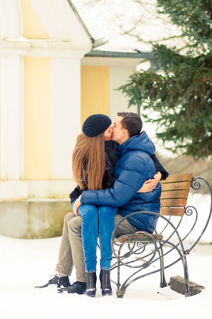 Lovers kissing on the bench