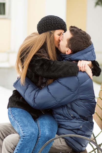 Photo lovers kissing on the bench