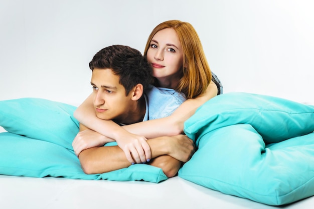 Lovers lie comfortably on cushions