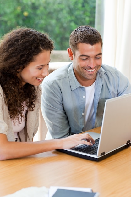 Lovers looking at their laptop at home