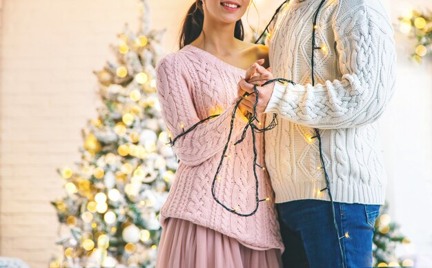 Lovers man and woman on a Christmas background. Selective focus.