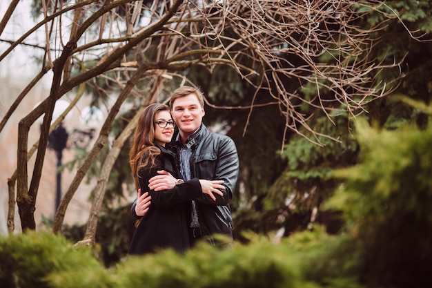 Lovers man and woman hugging outdoors