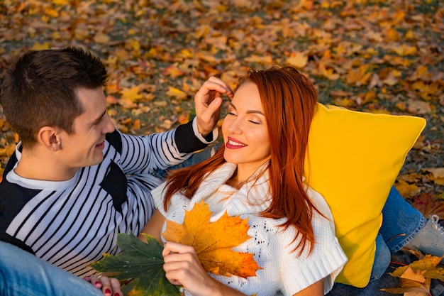 Lovers man and woman in the park in autumn