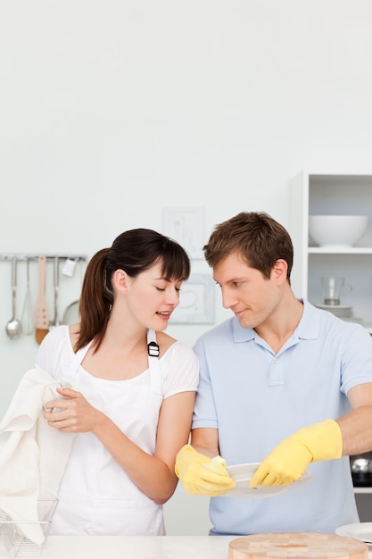 Lovers washing dishes together