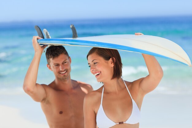 Lovers with their surfboard