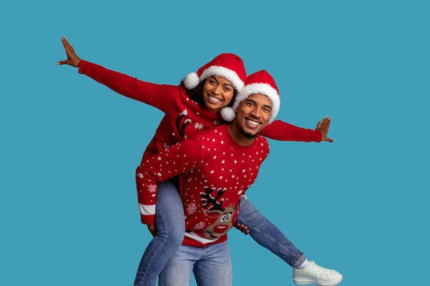 Loving african american couple having fun on blue celebrating xmas