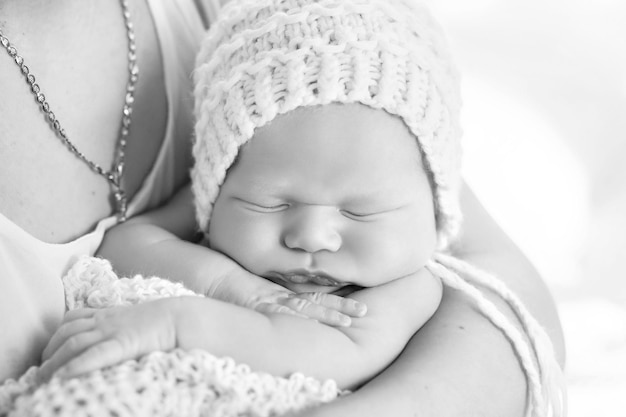 Loving baby sleeping in mother's hands Closeup picture