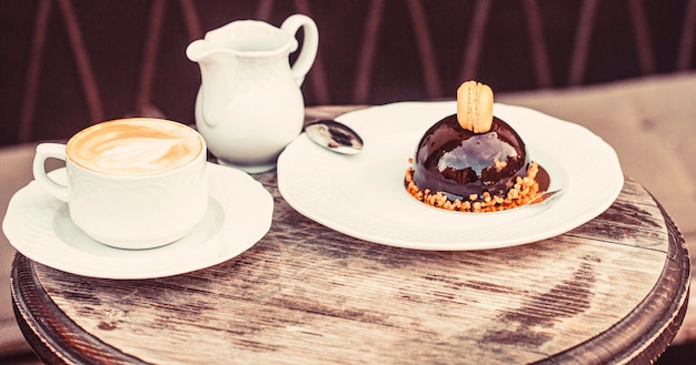 Loving coffee Cup of fresh cappuccino Chocolate cake Closeup Tasty chocolate cake