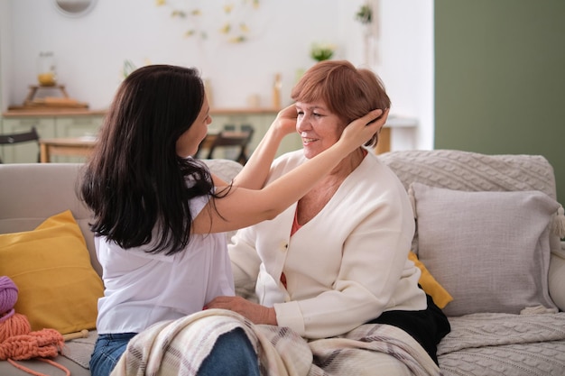 Loving connection between a mother and her grown daughter during a cozy conversation on a couch