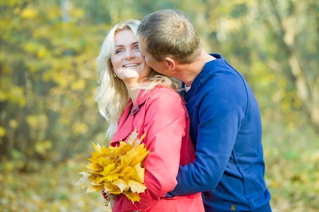 Loving couple in the autumn park Spouses of middle age for a walk