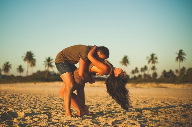 Photo loving couple on the beach having fun