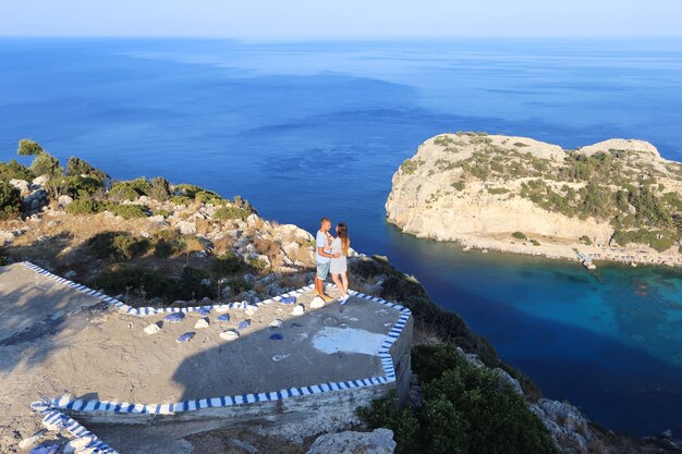 A loving couple, and a beautiful view of the sea.