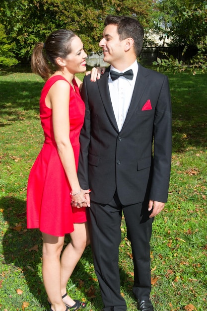 Loving couple in bright clothes dancing on the park