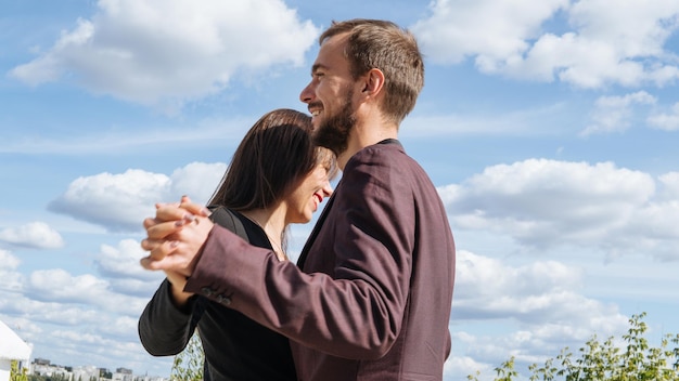 Loving couple dancing in the street Young happy loving couple walking outdoors at the street having fun A loving couple is dancing and having fun