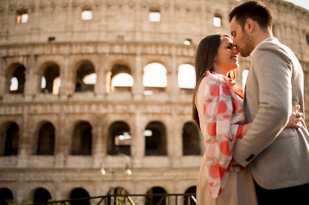 Loving couple in front of the Colosseum in Rome, Italy