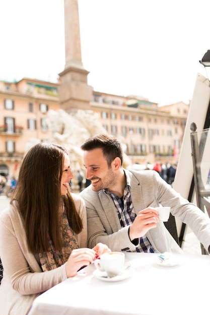 Loving couple having a cup of coffee in a cafe in Rome