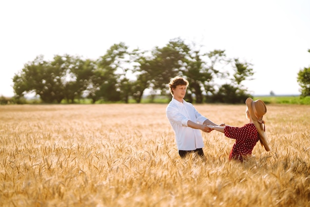 Loving couple having fun and enjoying relaxation in a wheat field