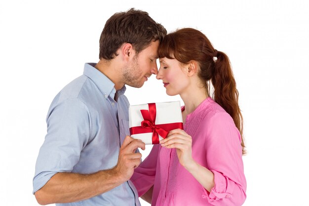 Loving couple holding a gift