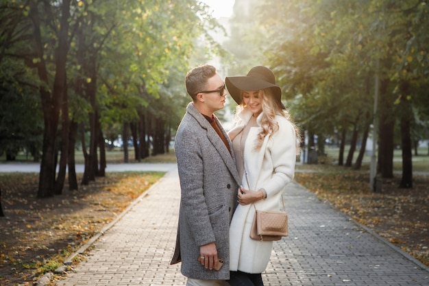 Loving couple hugging on a pavement alley in the park.