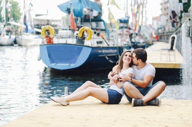 Loving couple hugging on pier in summer