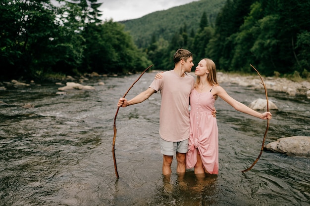 Loving couple hugging in the river in summer