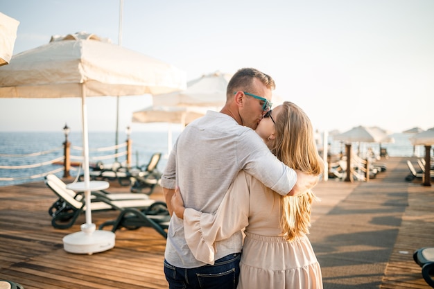 A loving couple is resting at the sea in Turkey. Man and woman on the pier. Sea tour. Honeymoon. Couple on a honeymoon trip. A beautiful couple travels the world. Happy couple on vacation.