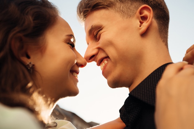 Loving couple kissing outdoor at sunset