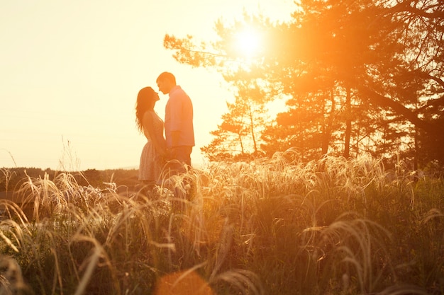 Loving couple kissing at sunset