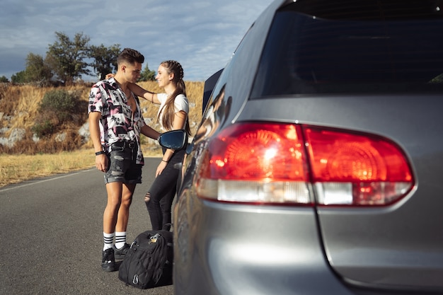 Loving couple leaning on the car