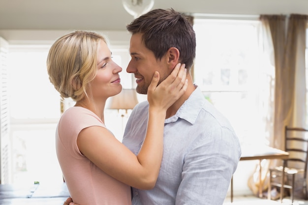 Loving couple looking at each other at home