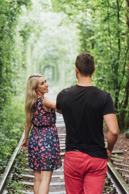 Loving couple in love tunnel iron road