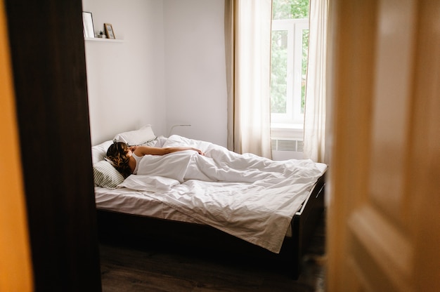 Photo loving couple lying on bed in the bedroom