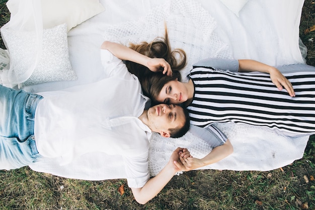 Loving couple lying on ground