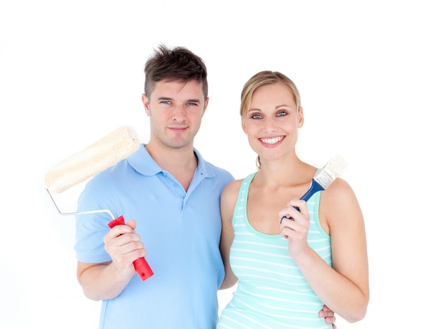 Loving couple painting  in their new house 