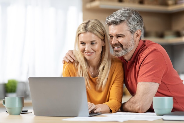 Loving couple paying bills on Internet together