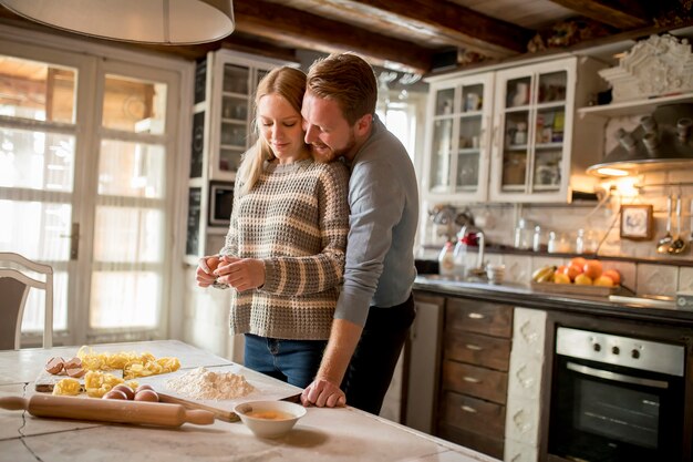 Loving couple preparing pasta in the kitchen