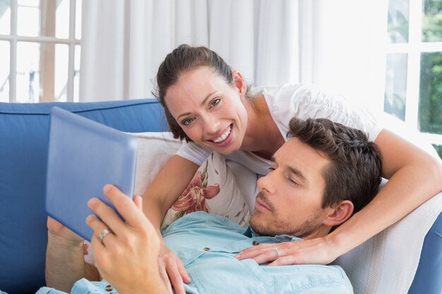 Loving couple reading book on couch