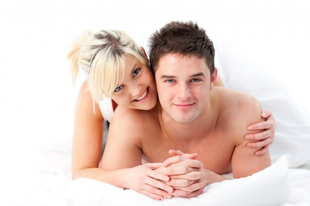 Loving Couple relaxing on bed 