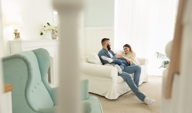 Loving Couple Relaxing On Sofa In Living Room